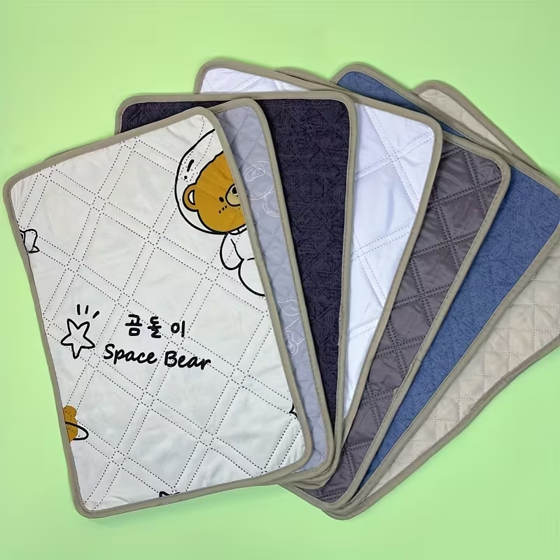 Pet training potty mats with cute cartoon dog and cat designs.