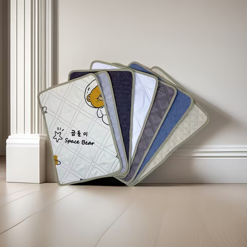 Pet training potty mats with cute cartoon dog and cat designs.
