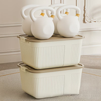 Three plastic storage boxes with lids, snaps, and handles, suitable for home organization.