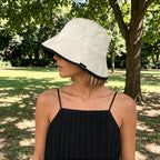 Reversible bucket hat with a narrow brim.